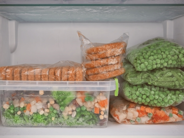 Alimentos empacotados em alguns sacos plásticos e em potes, para o congelamento.