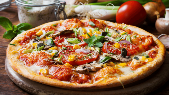 Pizza vegetariana coberta com queijo mussarela, tomate, brócolis, cebola, pimentão e cogumelo. 